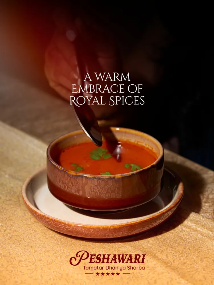 Peshawari Tamatar Dhaniya Shorba post: tomato soup being served in a glazed bowl